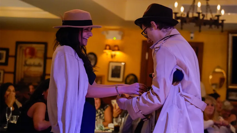 A Murder Mystery Company detective questioning a guest at a New Jersey show
